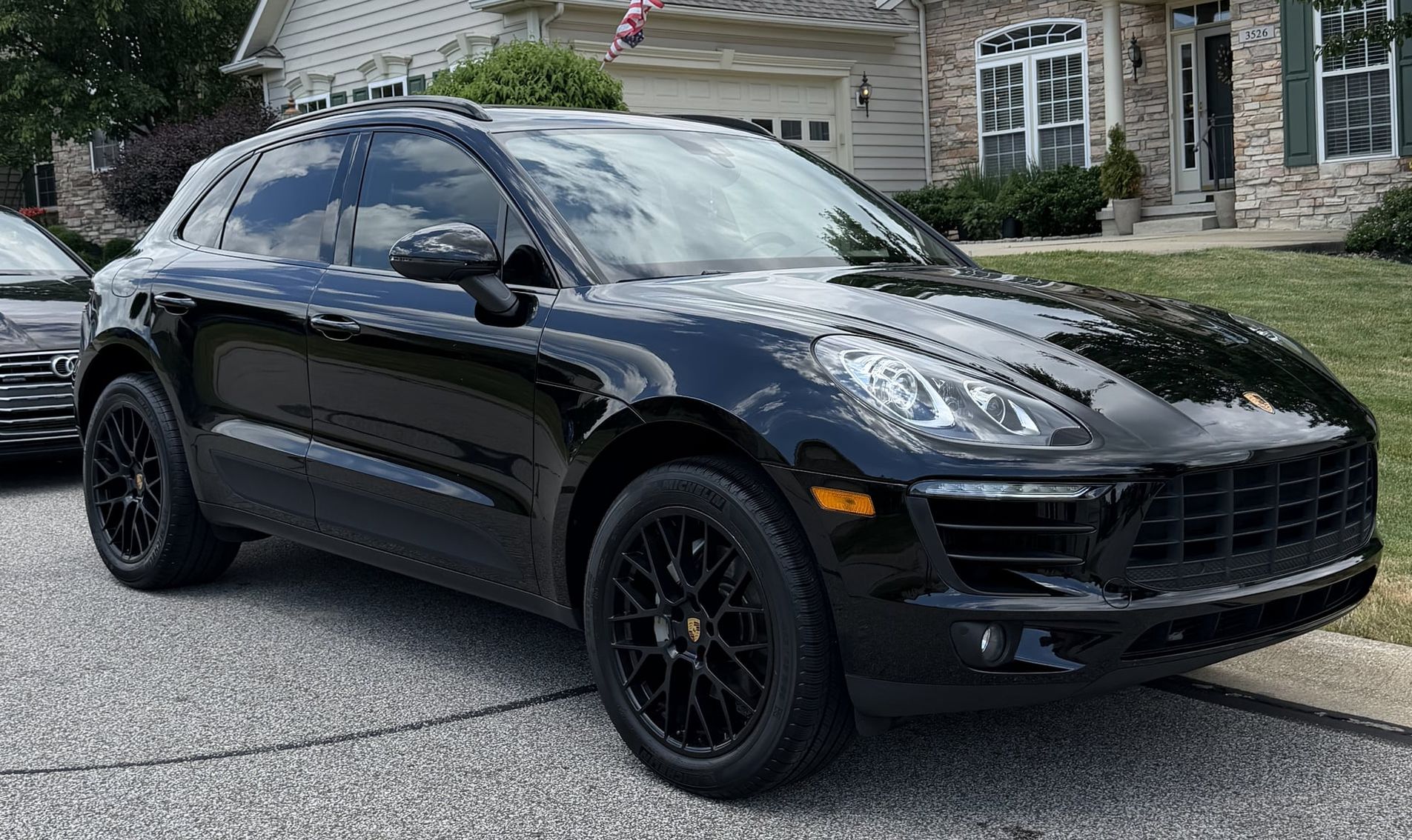 black Porsche Macan detailed in a customer driveway