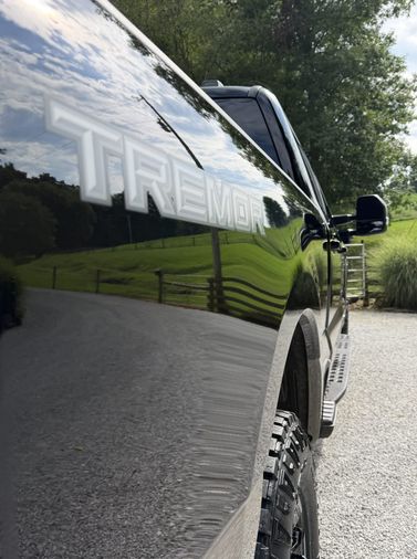 mirror reflection in freshly detailed black truck paint
