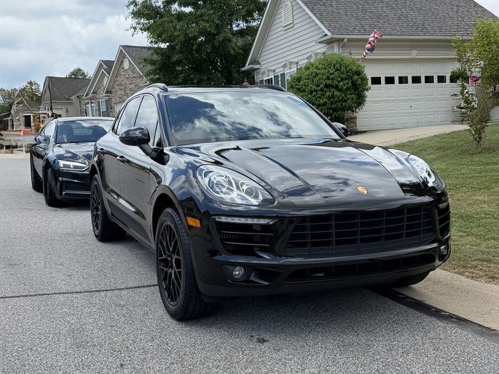 black Porsche Macan detailed in a customer driveway