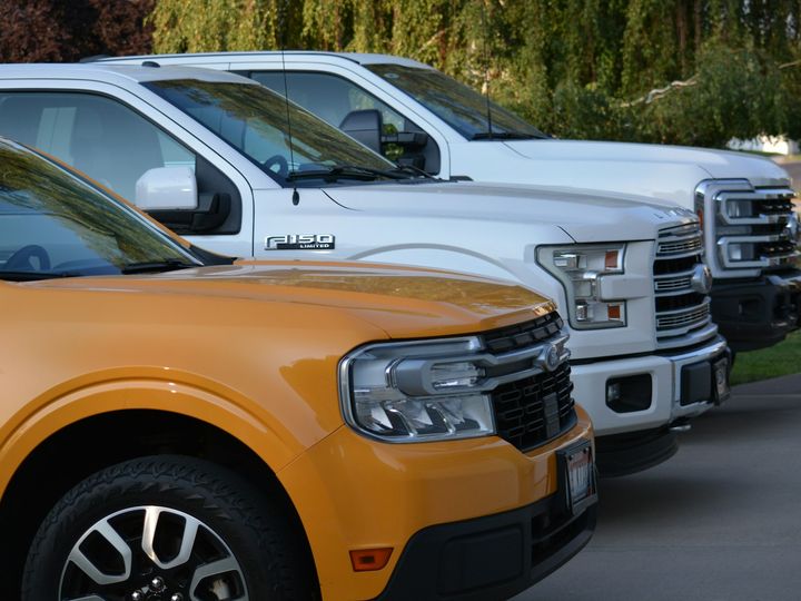 row of clean company pickup trucks lined up after fleet detailing