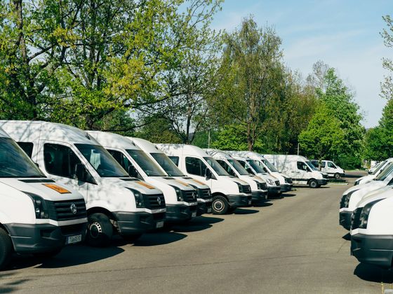 row of clean white company vans